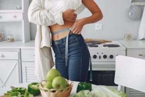 beautiful-sporty-woman-kitchen-with-vegetables